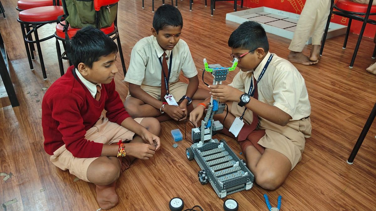 Students building a robotics crane in a STEM lab