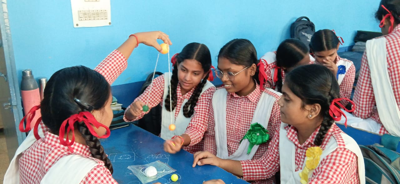 Girls engaged in hands-on STEM experiments in class